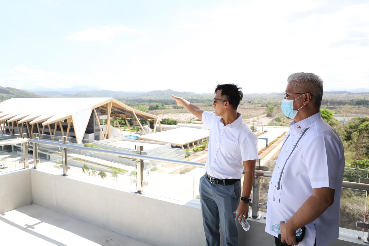 Photo caption: BCDA Senior Vice President Arrey Perez shows DND Spokesperson Arsenio Andolong a bird’s eye view of the world-class sports facilities from the seventh floor of the Government Building. BCDA photo