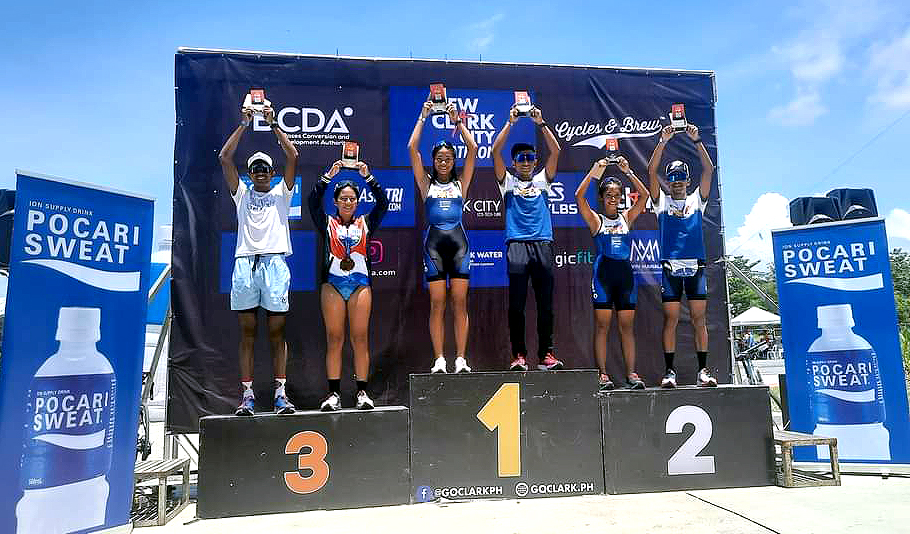 Photo caption: The Elites. Top racers from the Elite Men and Women categories wear their victory smiles during the awarding ceremony of the New Clark City Duathlon on 17 July 2022. (Per rank and category) Elite Men category: Raymund Torio (1st place), John Leerams Chicano (2nd place), and John Patrick Ciron (3rd place). Elite Women category: Merry Joy Trupa (1st place), Elaine Quismundo (2nd place) and Pawie Fornea (3rd place). (Photo courtesy: GoClark)